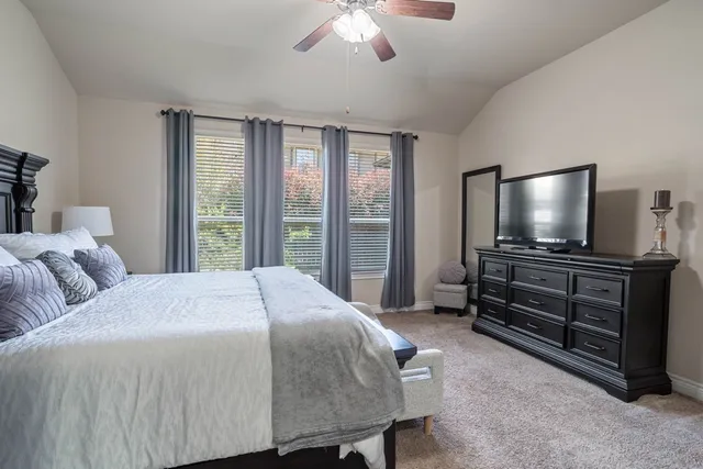 a bathroom with a tub sink shower and two mirror