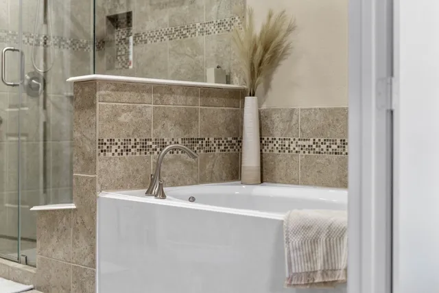 a bathroom with a bathtub and shower