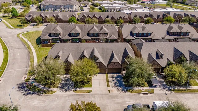 an aerial view of residential houses with outdoor space