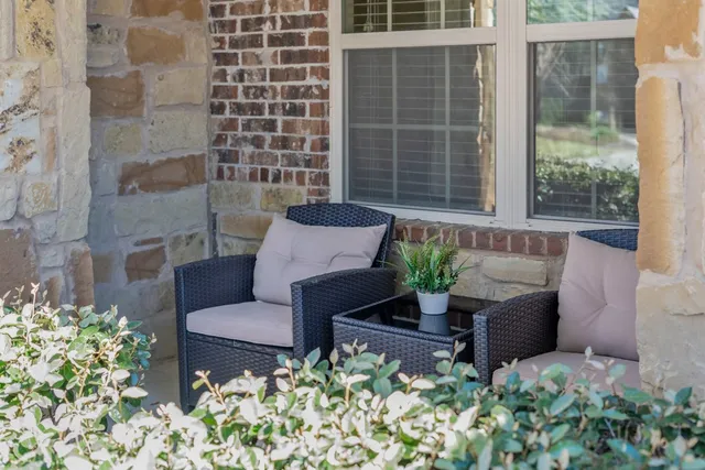 a wooden bench sitting in front of a building