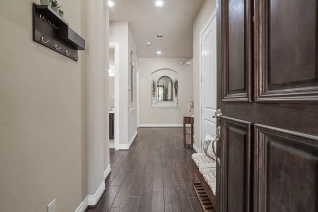 a view of hallway with wooden floor