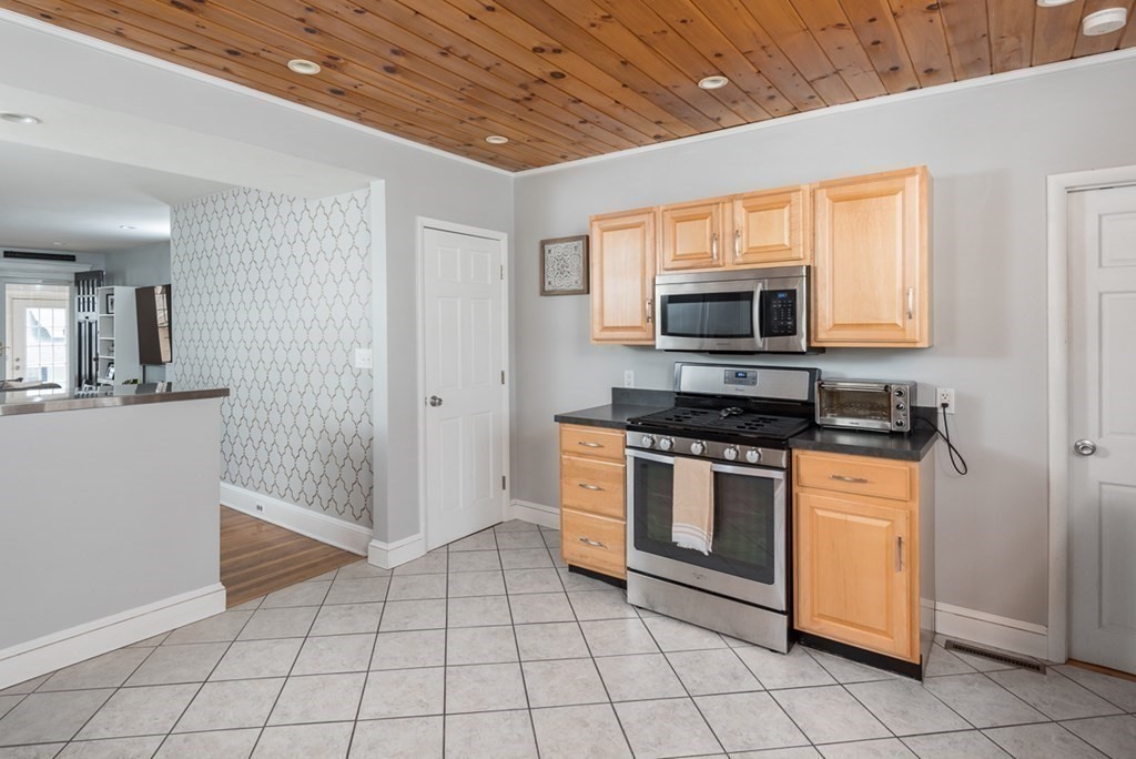 39 Edgemont Road Braintree, MA 02184 - Photo 11 of 39 a kitchen with granite countertop a stove a microwave and a sink