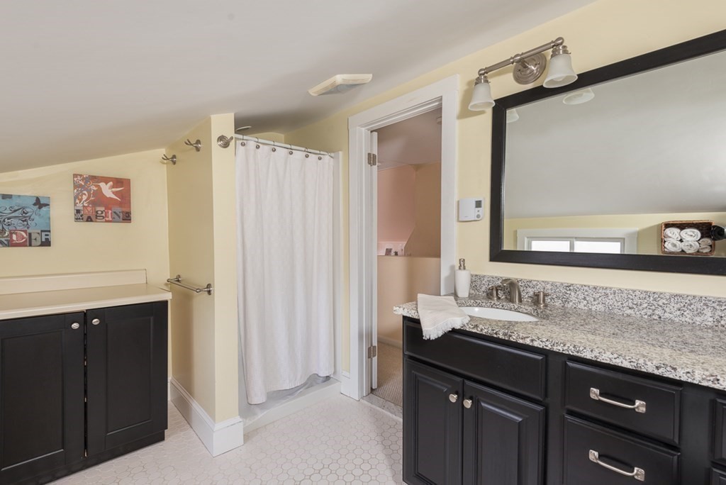39 Edgemont Road Braintree, MA 02184 - Photo 30 of 39 a bathroom with a granite countertop sink and a mirror