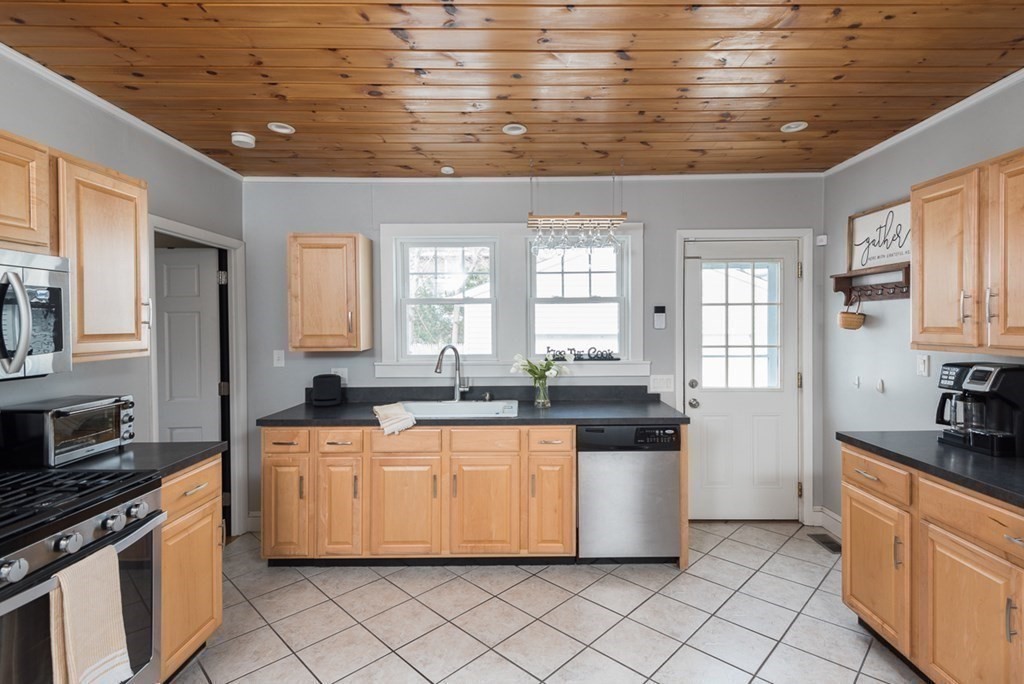 39 Edgemont Road Braintree, MA 02184 - Photo 8 of 39 a kitchen with stainless steel appliances granite countertop a sink and cabinets