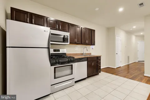 a white refrigerator freezer sitting in a kitchen
