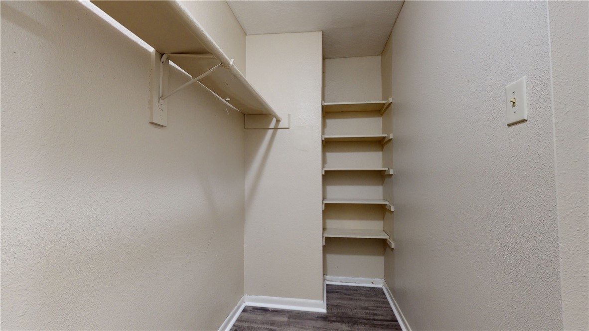 725 Peppertree Drive, Unit 23 Bryan, TX 77801 - Photo 13 of 16 Spacious closet featuring dark wood-style floors