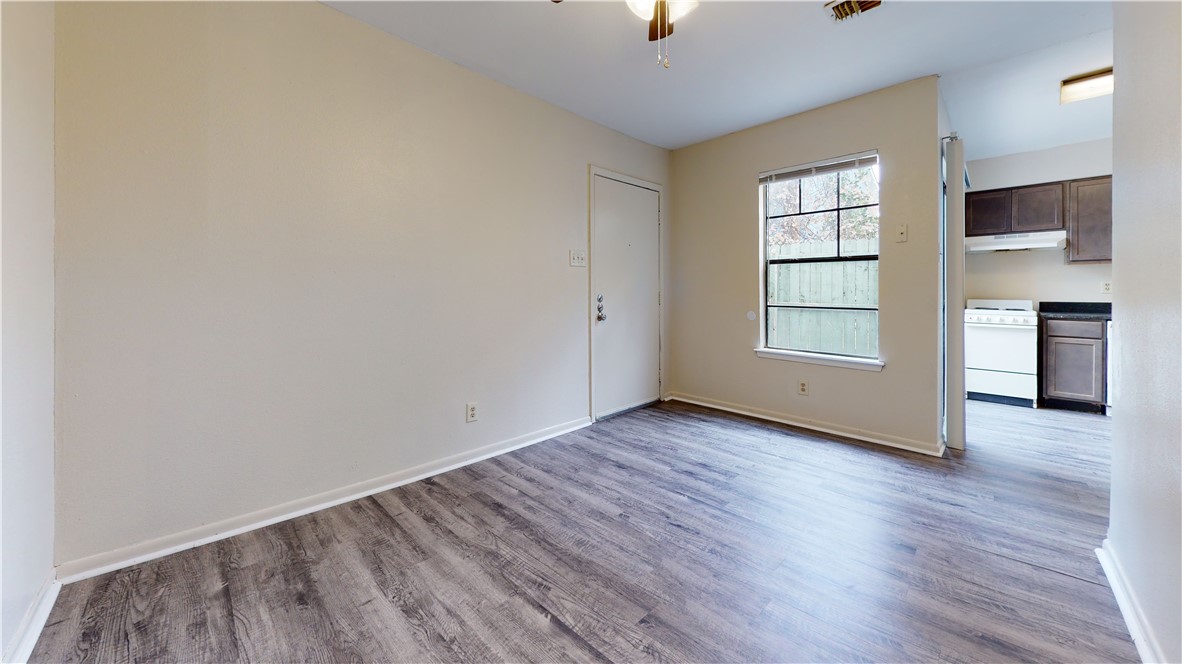 725 Peppertree Drive, Unit 23 Bryan, TX 77801 - Photo 4 of 16 Spare room with wood finished floors and a ceiling fan