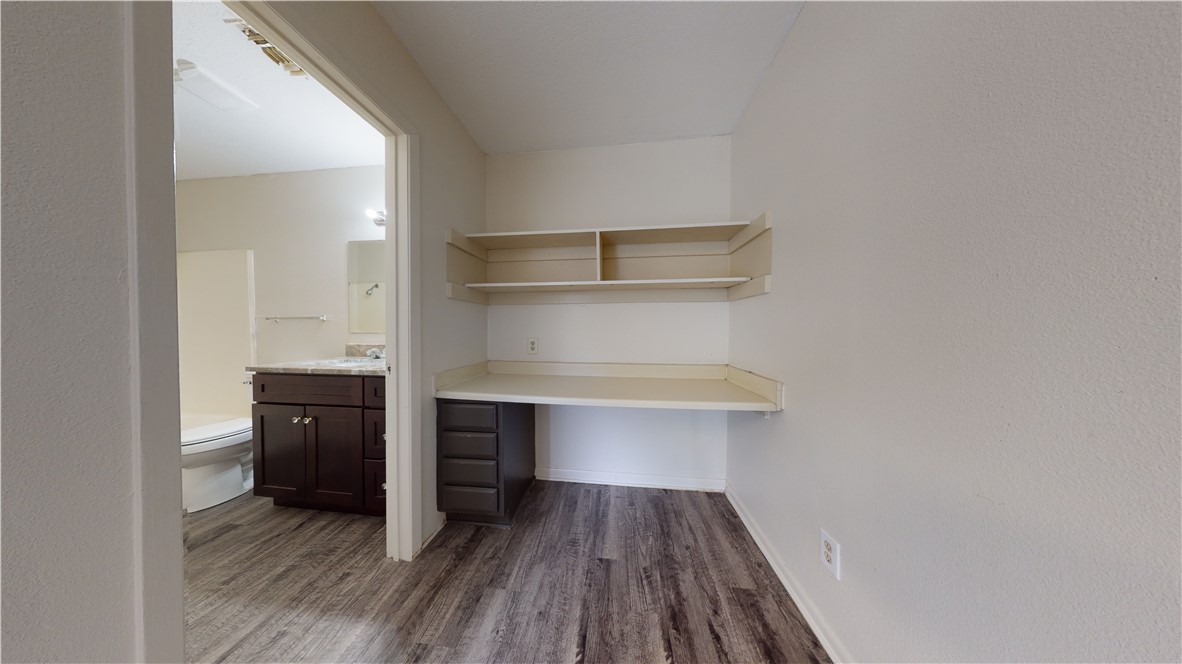 725 Peppertree Drive, Unit 23 Bryan, TX 77801 - Photo 9 of 16 Unfurnished office featuring dark wood-style floors and baseboards