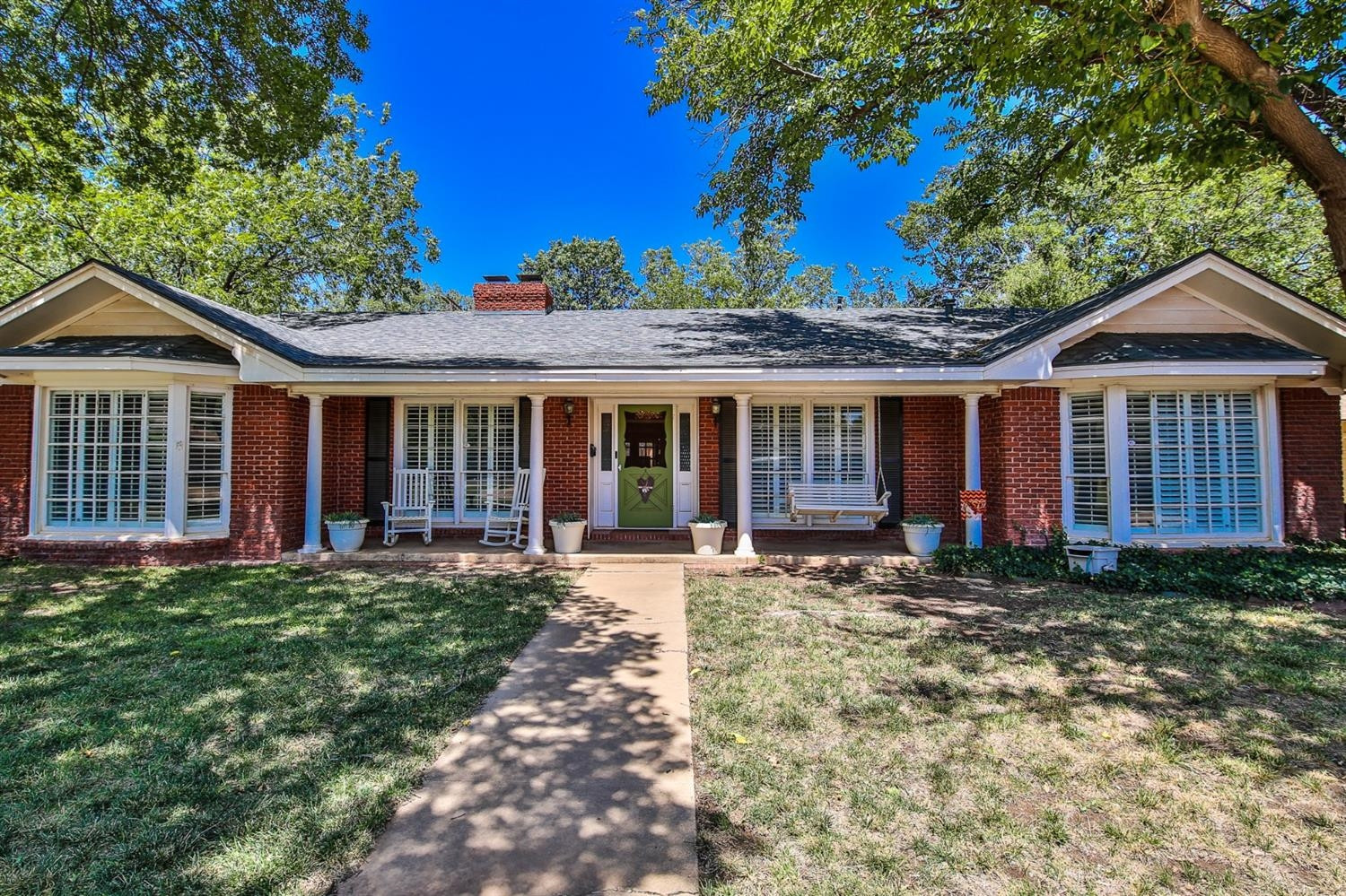 3204 55th Street Lubbock, TX 79413 - Photo 1 of 41 a front view of a house with garden
