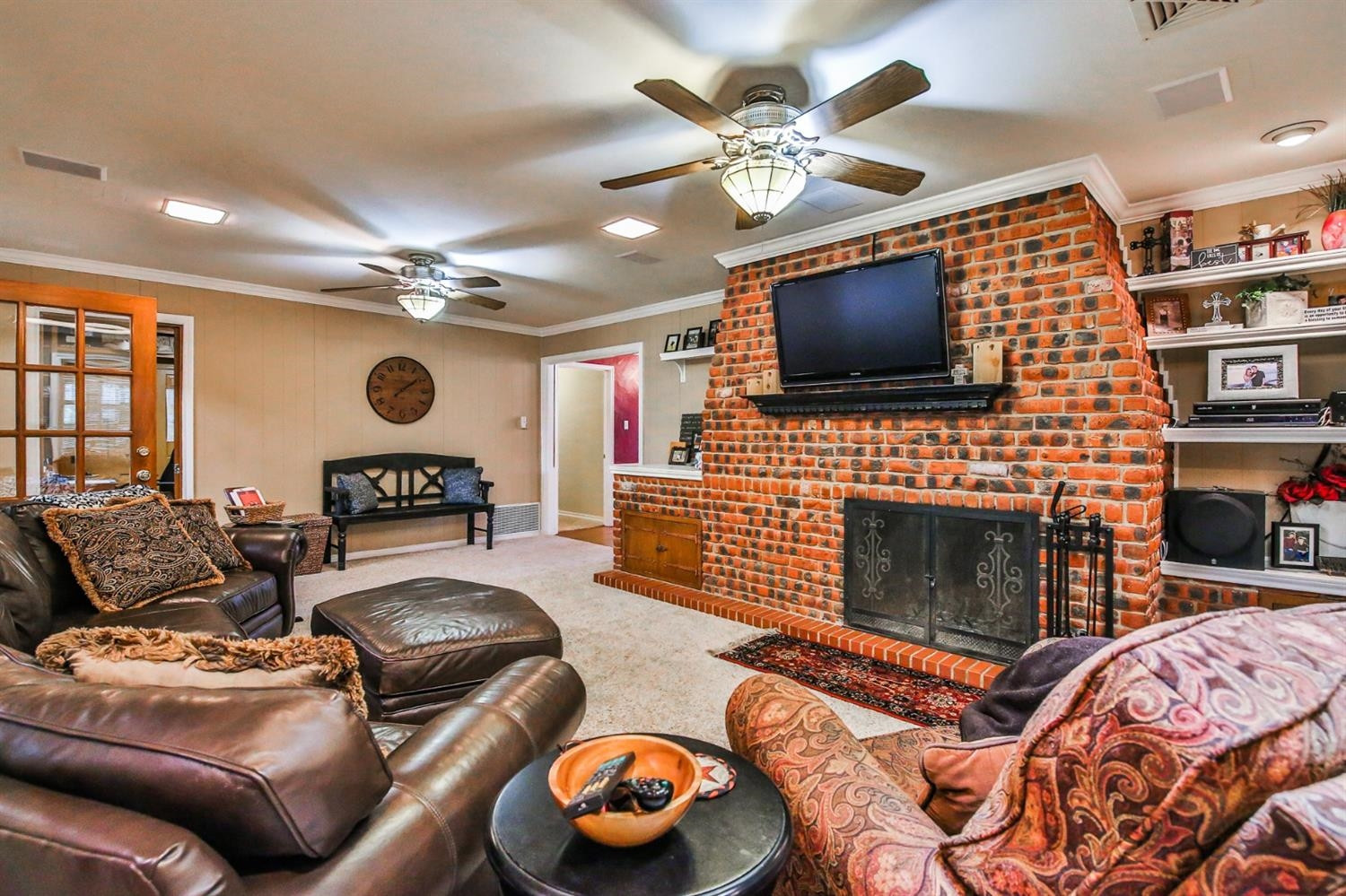 3204 55th Street Lubbock, TX 79413 - Photo 14 of 41 a living room with furniture a flat screen tv and a fireplace