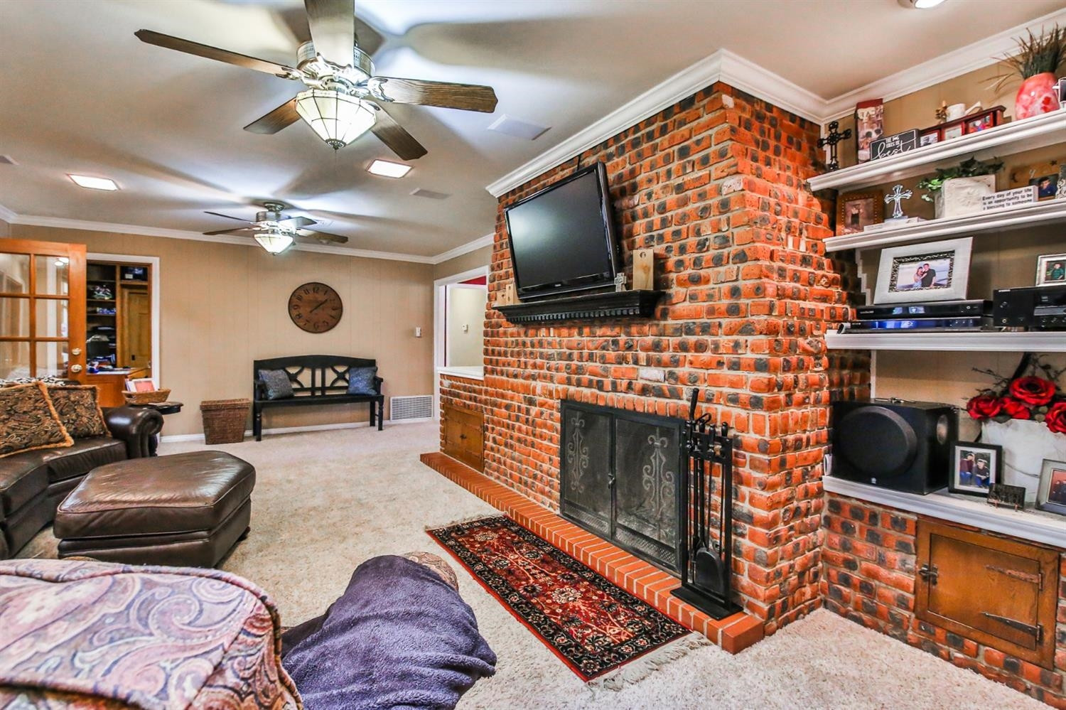 3204 55th Street Lubbock, TX 79413 - Photo 15 of 41 a living room with furniture a flat screen tv and a fireplace