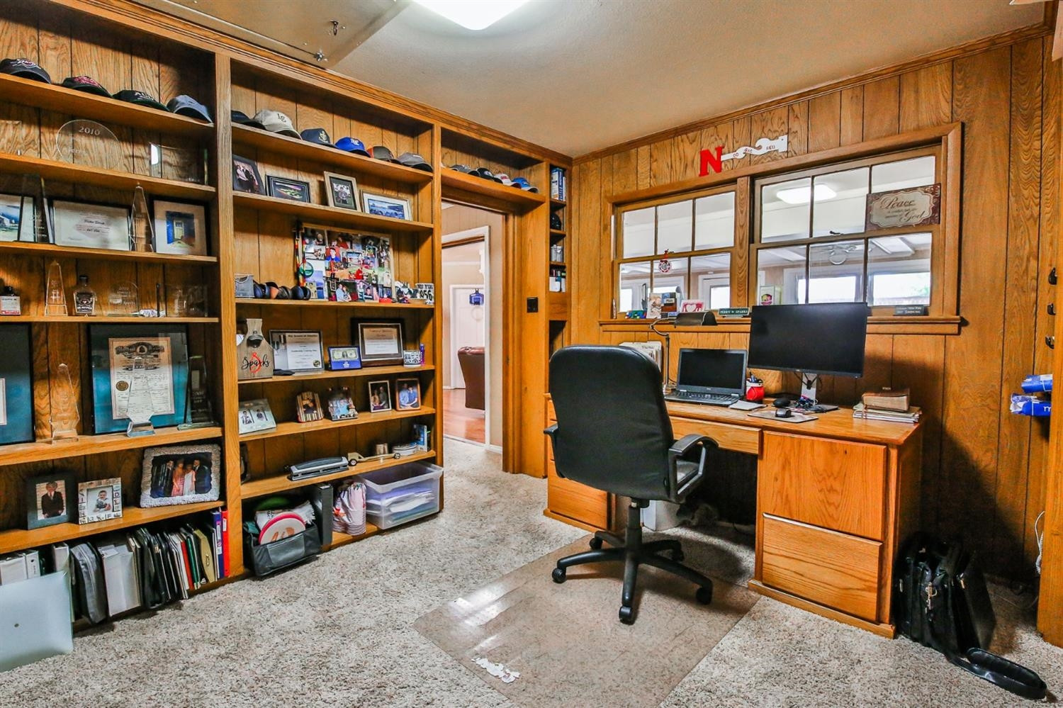3204 55th Street Lubbock, TX 79413 - Photo 19 of 41 a view of a workspace with bookshelf and a window