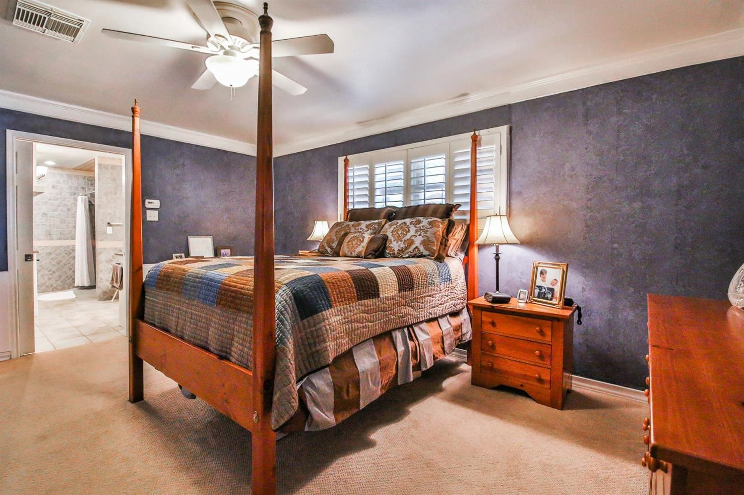 3204 55th Street Lubbock, TX 79413 - Photo 21 of 41 a bedroom with a bed and a chandelier