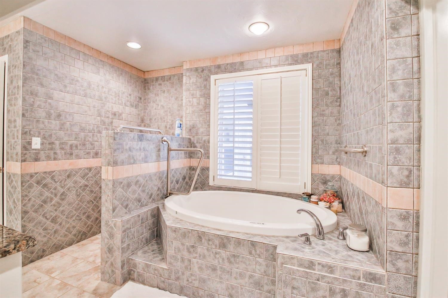 3204 55th Street Lubbock, TX 79413 - Photo 26 of 41 a bathroom with a granite countertop bathtub and shower