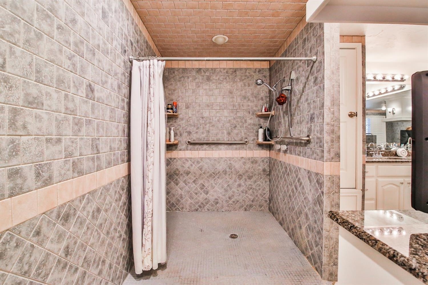 3204 55th Street Lubbock, TX 79413 - Photo 27 of 41 a bathroom with a shower and a sink