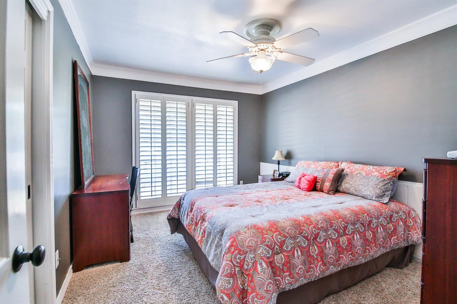 3204 55th Street Lubbock, TX 79413 - Photo 30 of 41 a bedroom with a large bed and a chandelier
