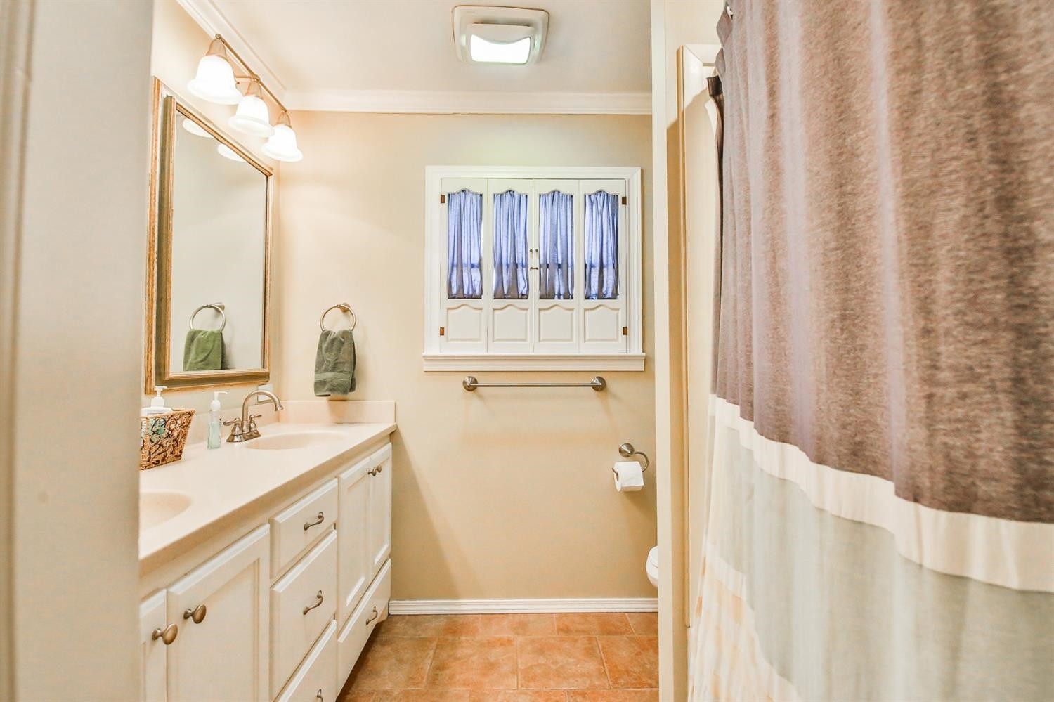 3204 55th Street Lubbock, TX 79413 - Photo 34 of 41 a bathroom with a sink a mirror and a shower