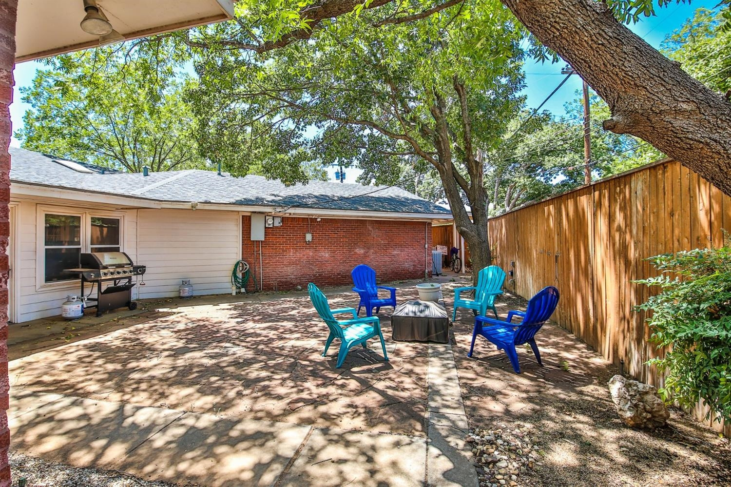 3204 55th Street Lubbock, TX 79413 - Photo 40 of 41 a backyard of a house with barbeque oven table and chairs