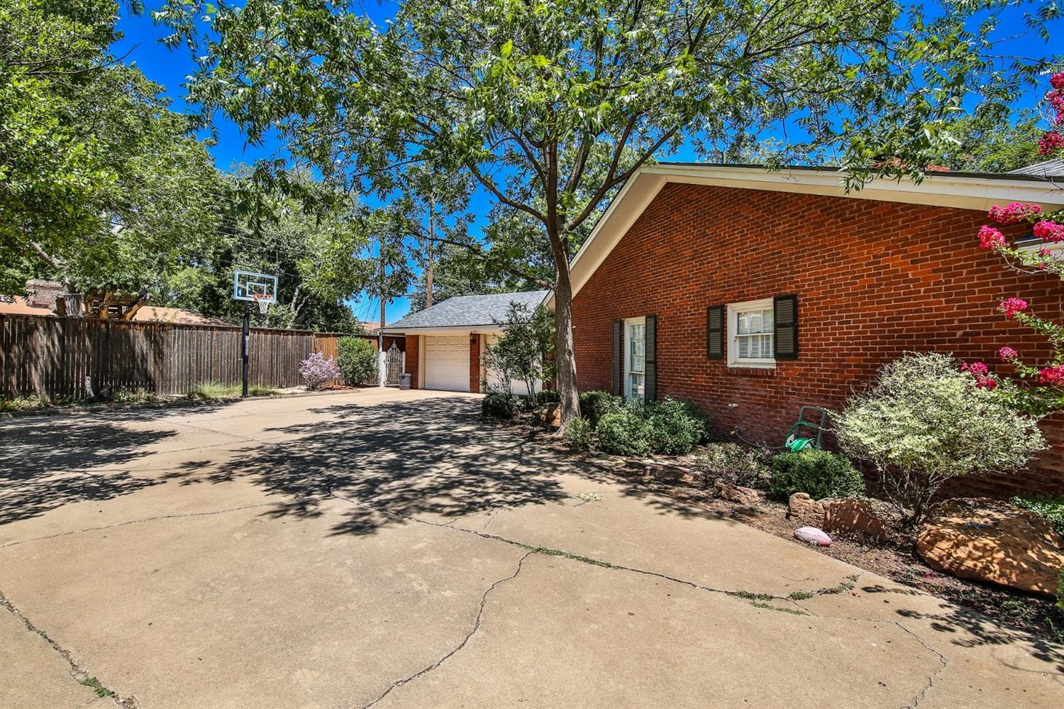 3204 55th Street Lubbock, TX 79413 - Photo 4 of 41 a front view of a house with a yard and a garage