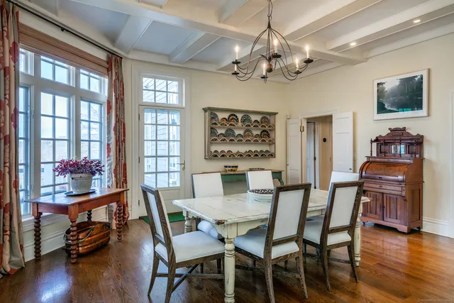 a living room with furniture a pool table and a large window