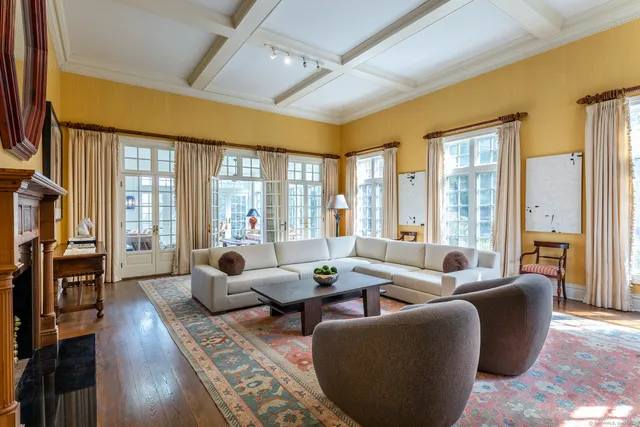 a living room with furniture and large windows