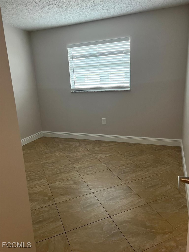 3325 Airport Road North, Unit T6 Naples, FL 34105 - Photo 9 of 13 a view of an empty room with a window
