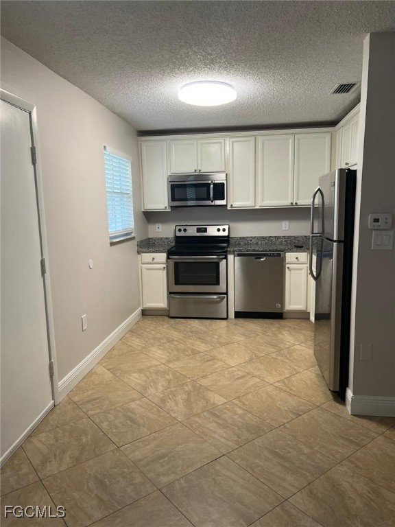 3325 Airport Road North, Unit T6 Naples, FL 34105 - Photo 10 of 13 a kitchen with stainless steel appliances granite countertop a stove a sink and a refrigerator