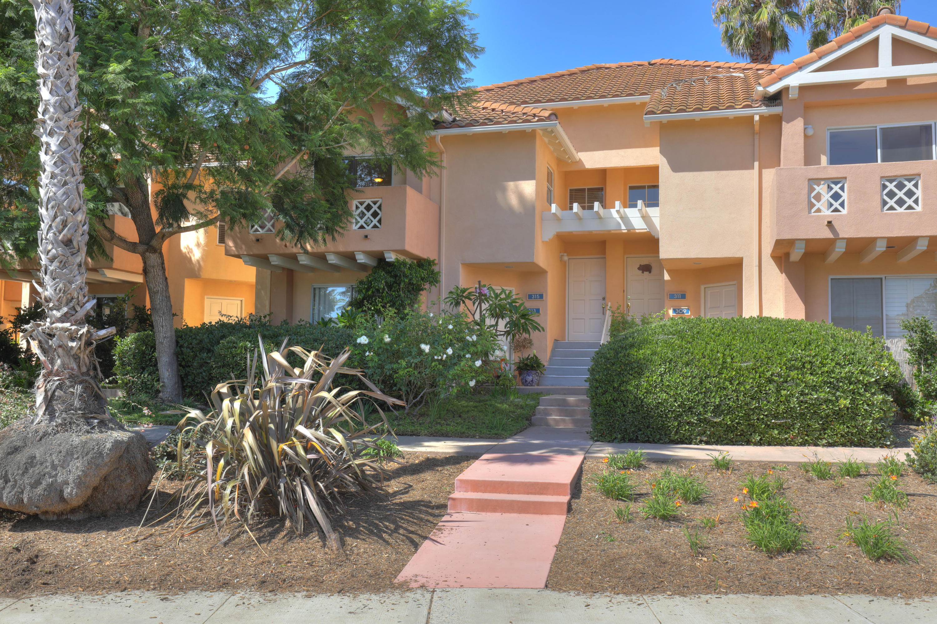 315 Pacific Oaks Road Goleta, CA 93117 - Photo 18 of 20 a front view of a house with a yard