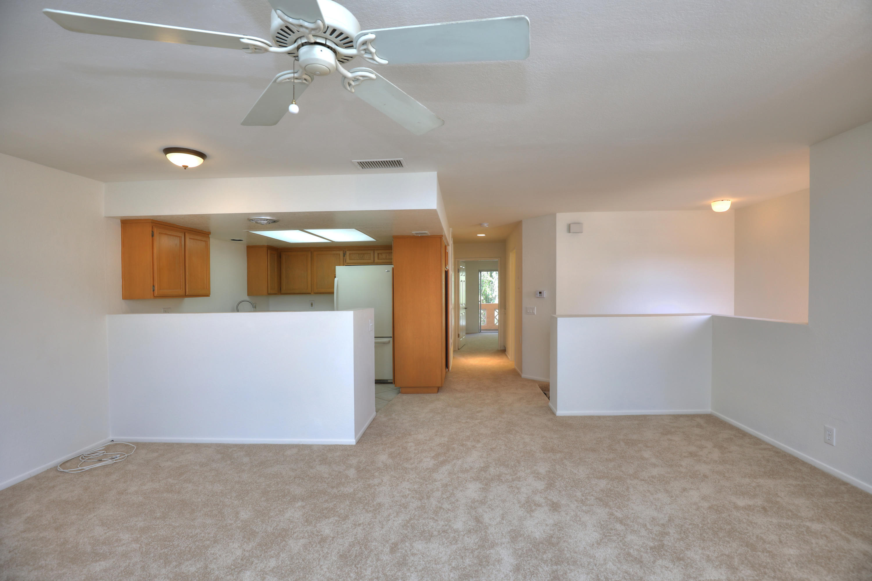 315 Pacific Oaks Road Goleta, CA 93117 - Photo 5 of 20 en empty room with fan and entrance
