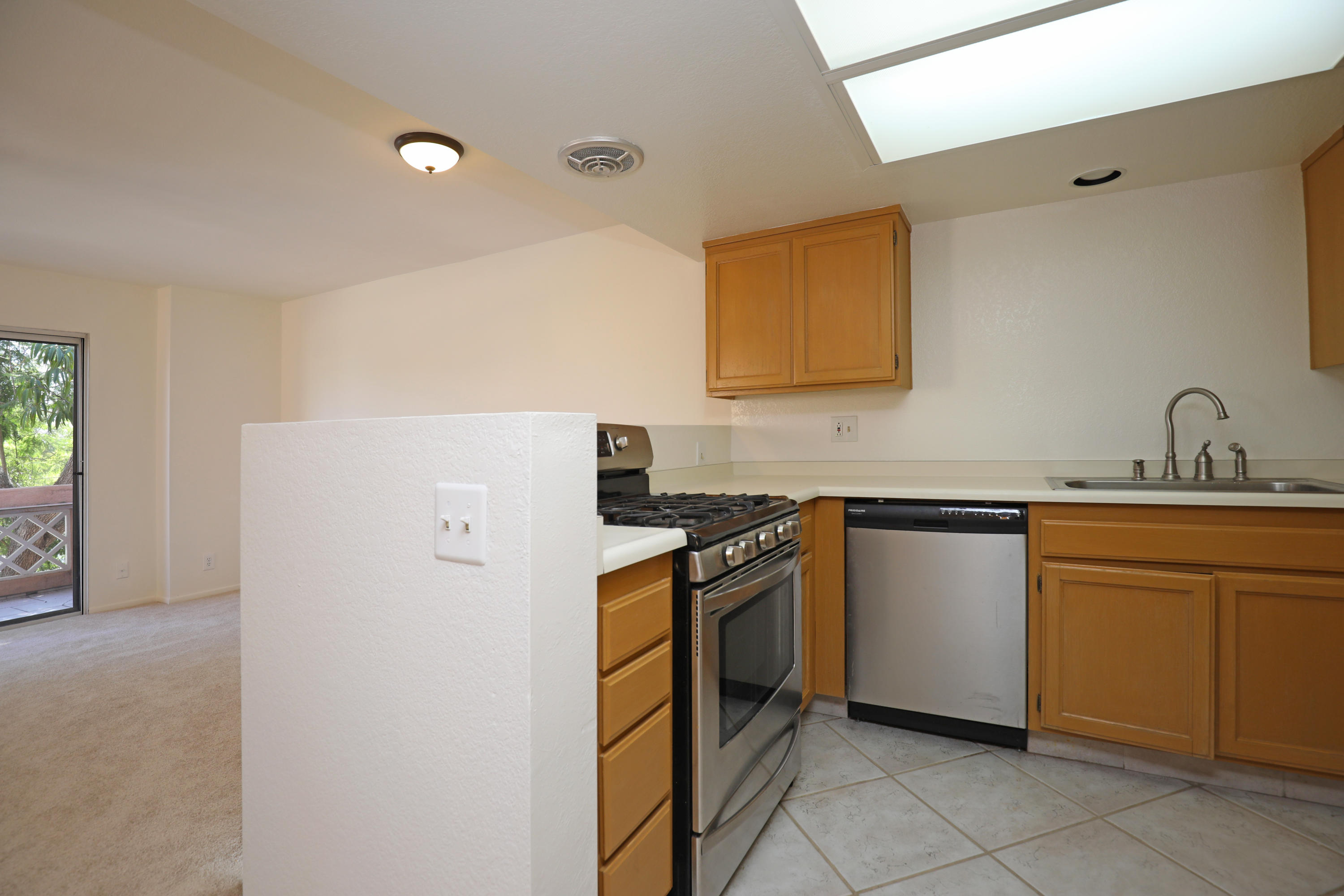 315 Pacific Oaks Road Goleta, CA 93117 - Photo 8 of 20 a kitchen with stainless steel appliances granite countertop a sink stove and refrigerator