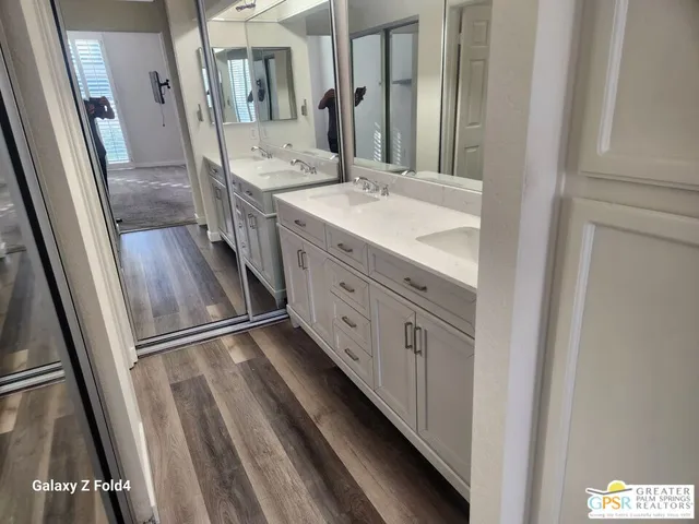 a bathroom with a double vanity sink and a mirror