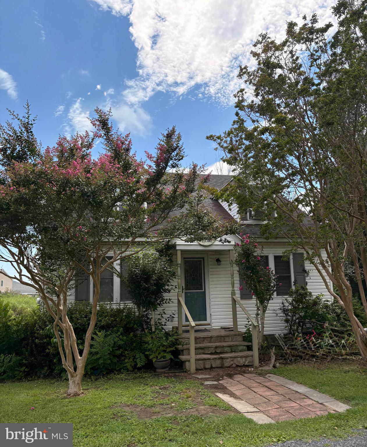a front view of a house with a garden