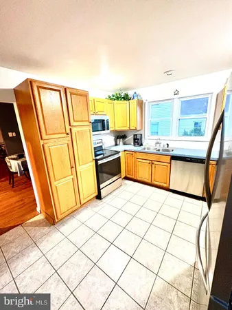 a kitchen with stainless steel appliances a refrigerator and a stove top oven