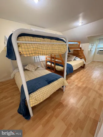 a living room with a couch and wooden floor