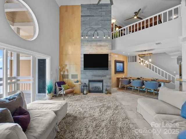 a living room with fireplace furniture and a flat screen tv