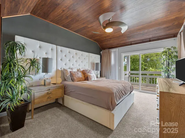 a spacious bedroom with a large bed and a large window