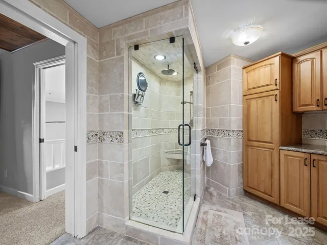 a bathroom with a shower and a sink
