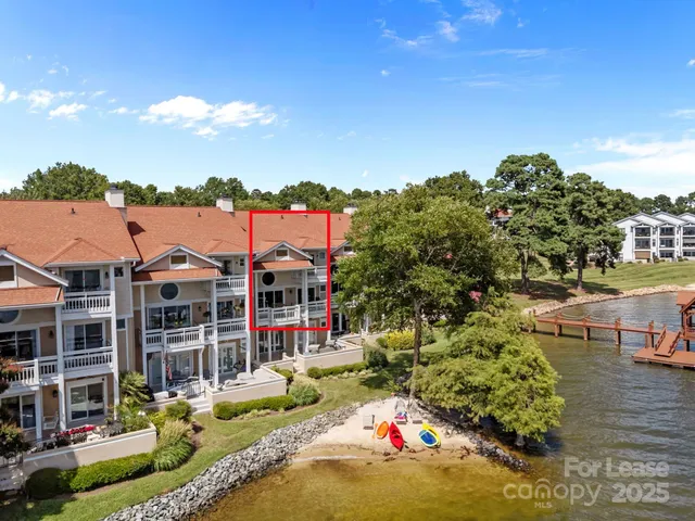 a view of a house with swimming pool and sitting area