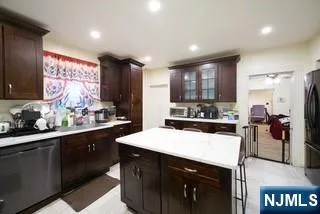 a kitchen with a sink a stove a refrigerator and cabinets