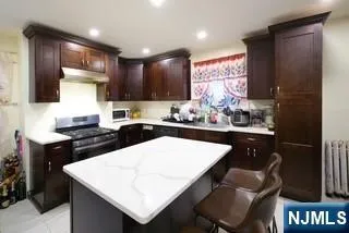 a kitchen with a dining table chairs and a refrigerator