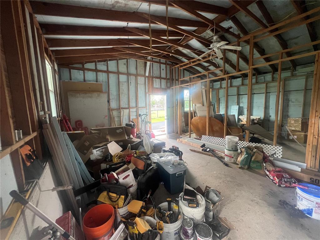 5855 Jack Brack Road St. Cloud, FL 34771 - Photo 47 of 86 a living room with furniture and a flat screen tv