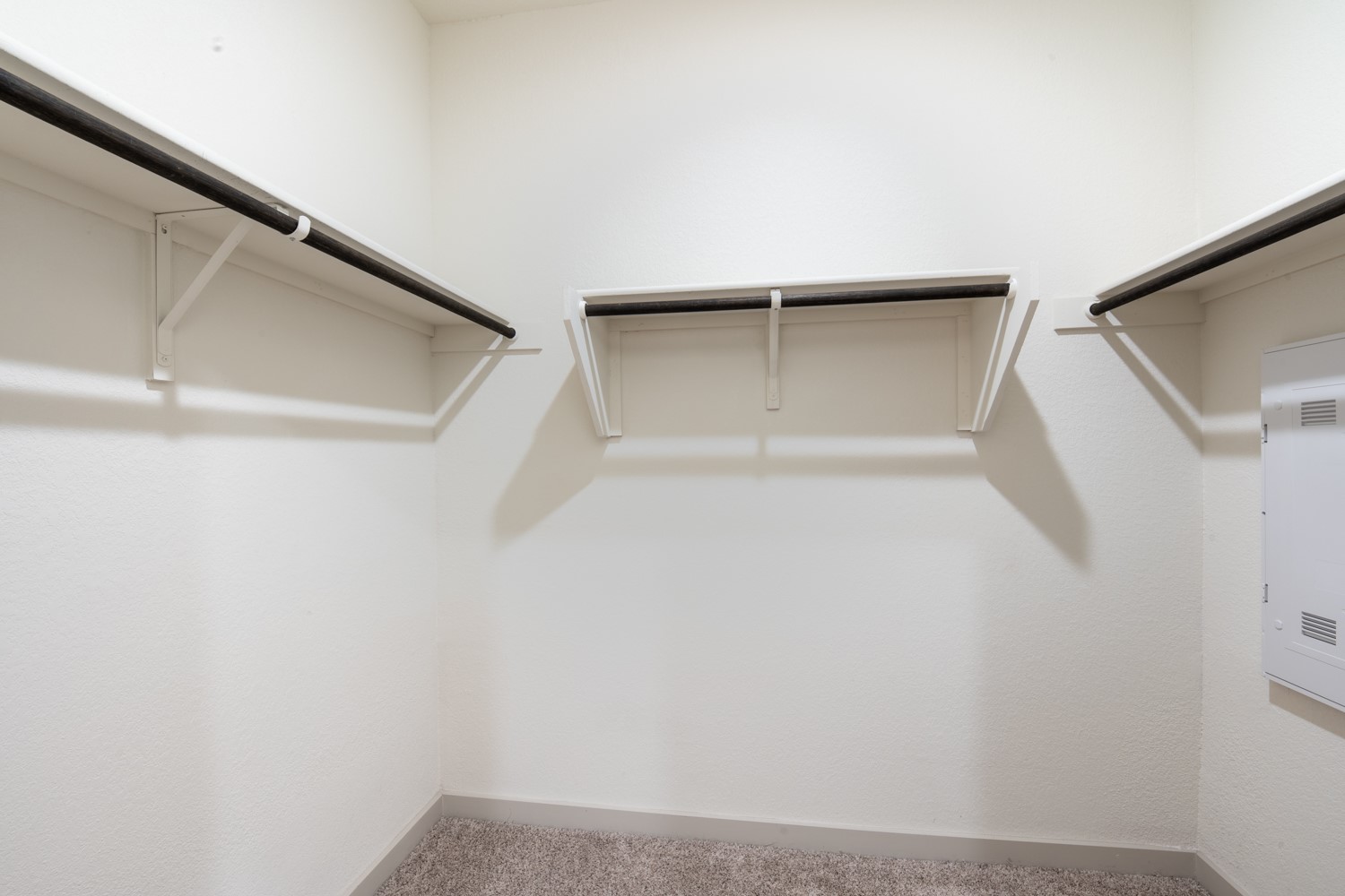 10801 Meris Lane Austin, TX 78754 - Photo 13 of 18 Functional closet featuring ample hanging space and neutral carpeting.
