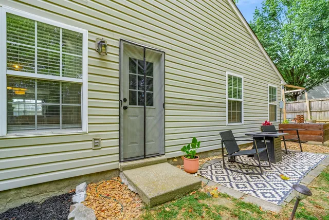 a view of a deck with couches table and chairs and potted plants