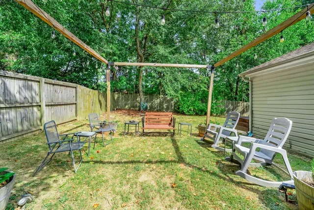 a view of backyard with a table and chairs
