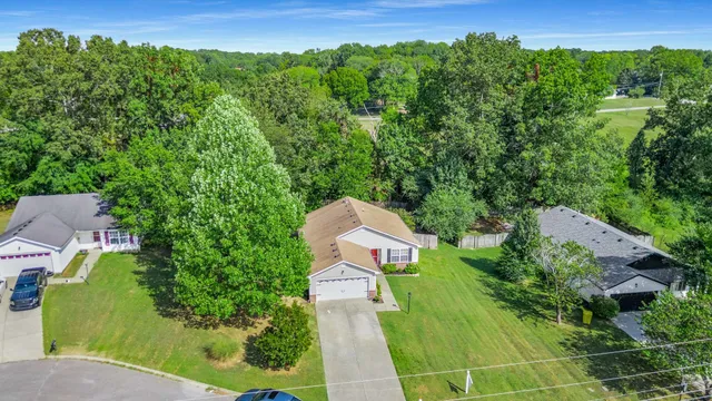an aerial view of a house with yard