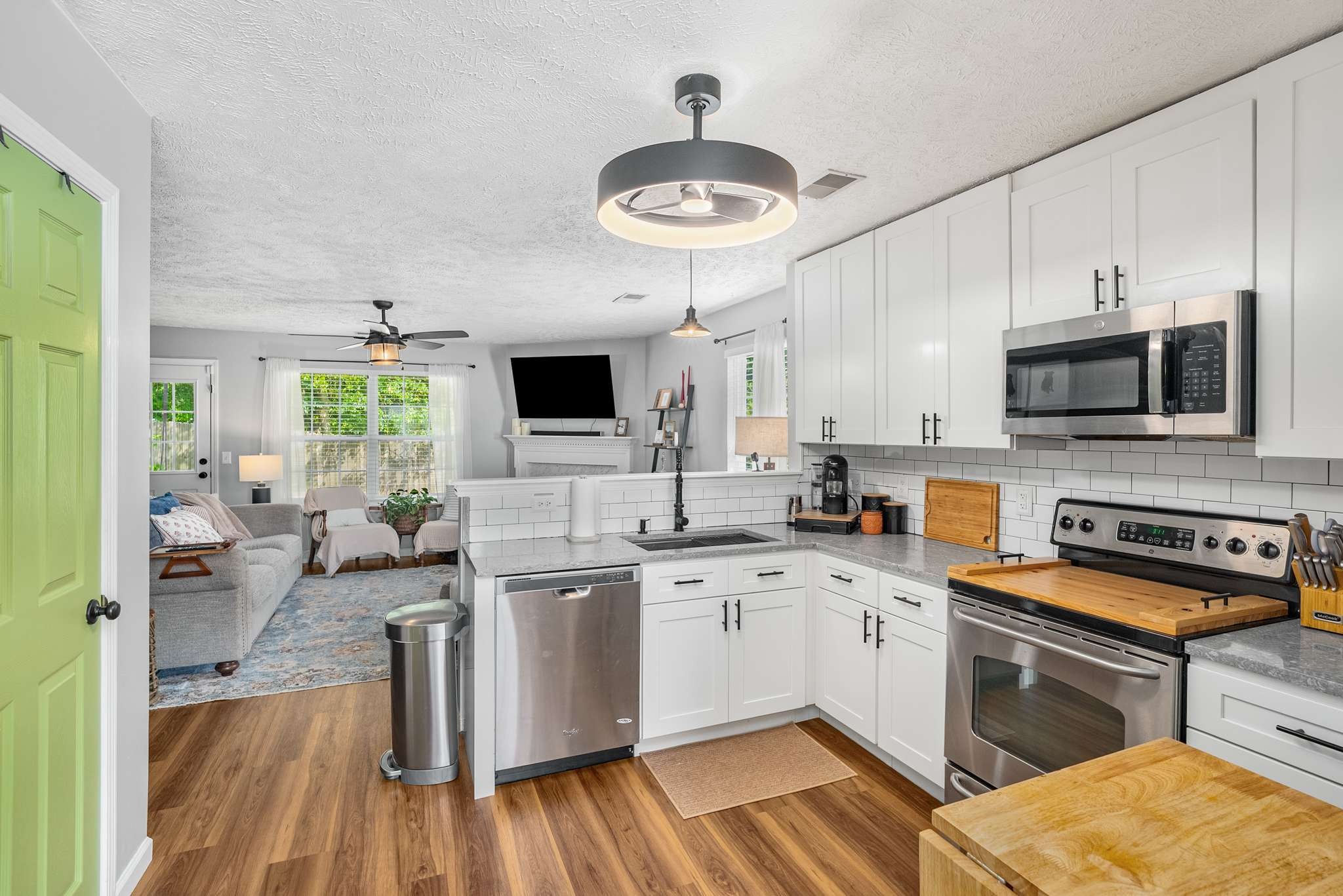 7222 Hidden Lake Drive Fairview, TN 37062 - Photo 9 of 21 a kitchen with stainless steel appliances a stove a sink dishwasher a microwave oven with cabinets and wooden floor