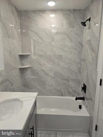 a bathroom with a bathtub and a sink