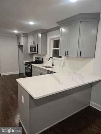 a kitchen with kitchen island sink stove and refrigerator
