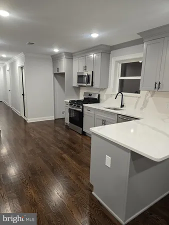 a large white kitchen with cabinets