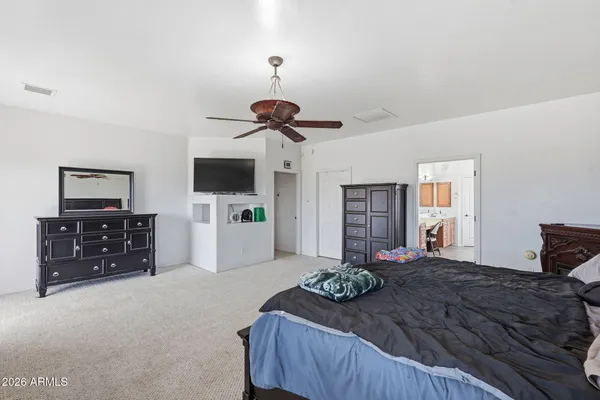 a bedroom with a bed and a flat screen tv